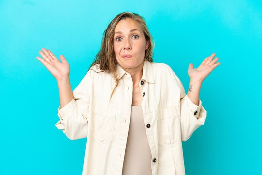 Woman shrugging shoulders not knowing what to decide.