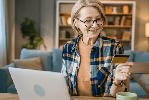 Woman looking at her credit card, pleased with herself
